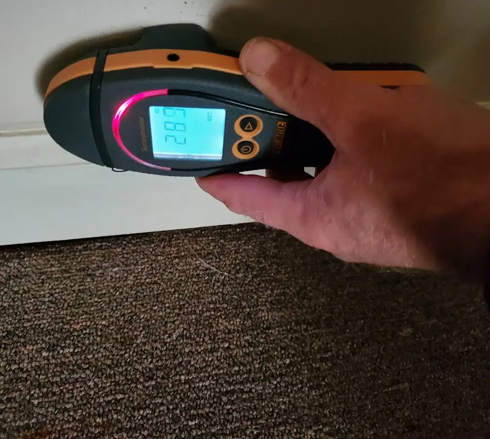 Moisture detection at baseboard during Storm Damage Restoration in Johnston
